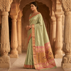 Woman in a traditional saree standing in an architectural setting