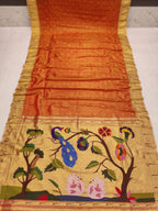 Saree with peacock and floral design on a plain background