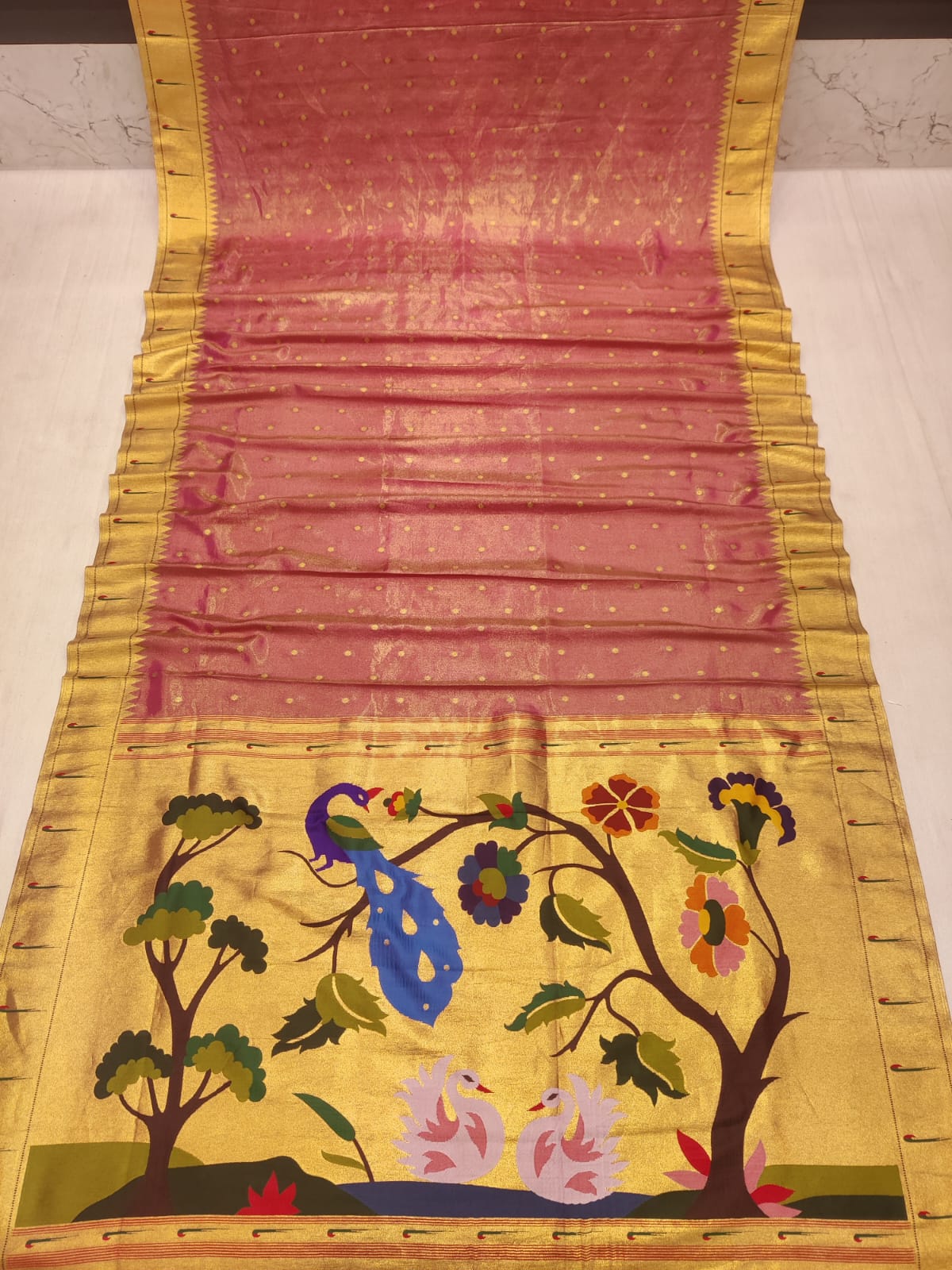 Decorative fabric with peacock and floral design on a yellow background