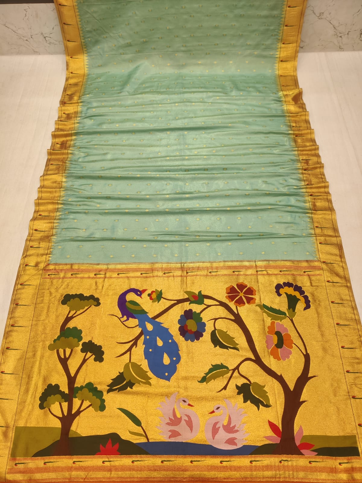 Decorative fabric with peacock design on a yellow background