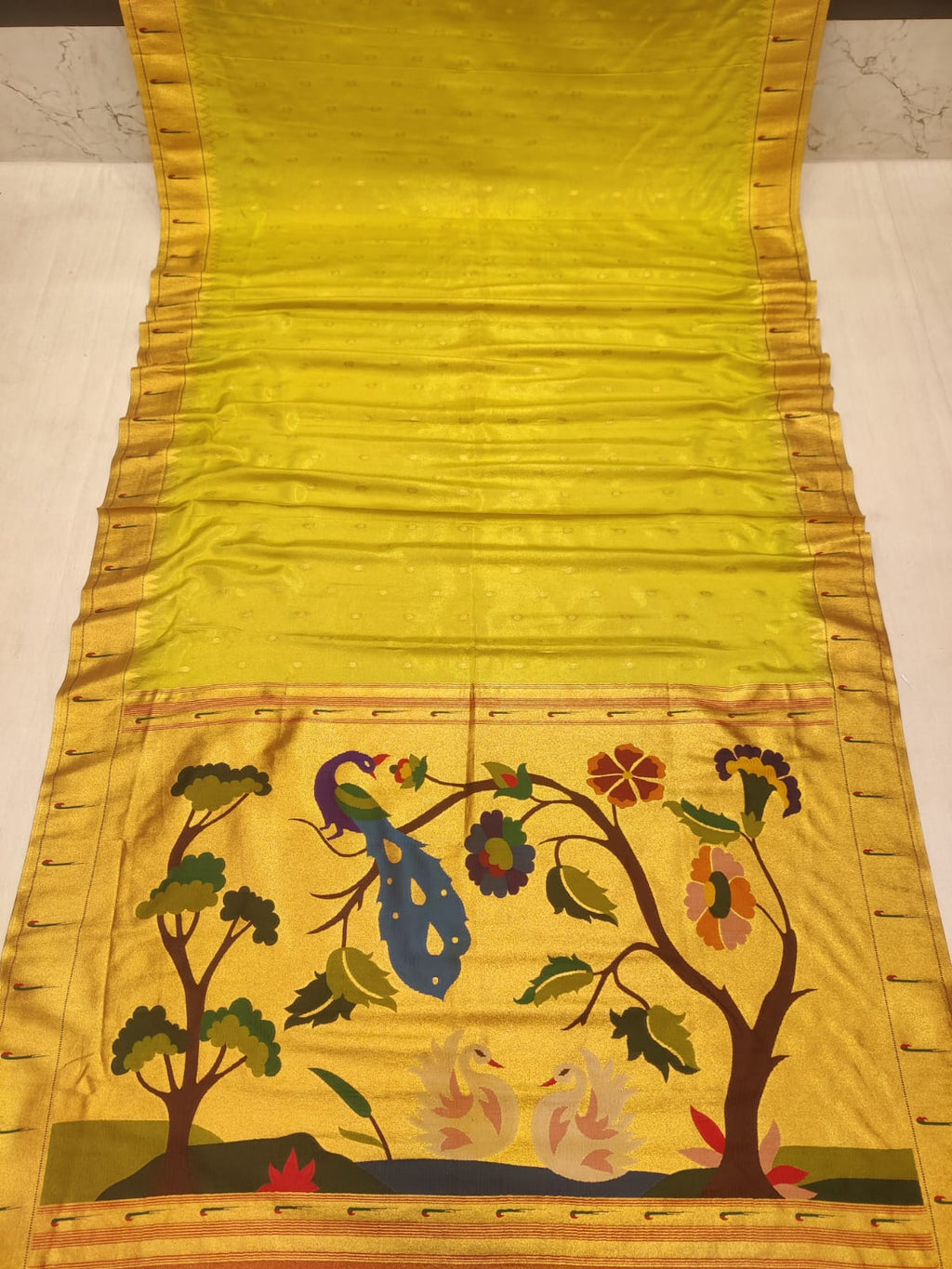 Yellow fabric with floral and peacock design
