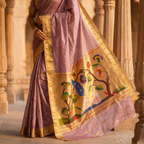 Woman wearing a traditional saree with intricate designs in an architectural setting