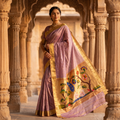 Woman in traditional attire standing in an architectural setting